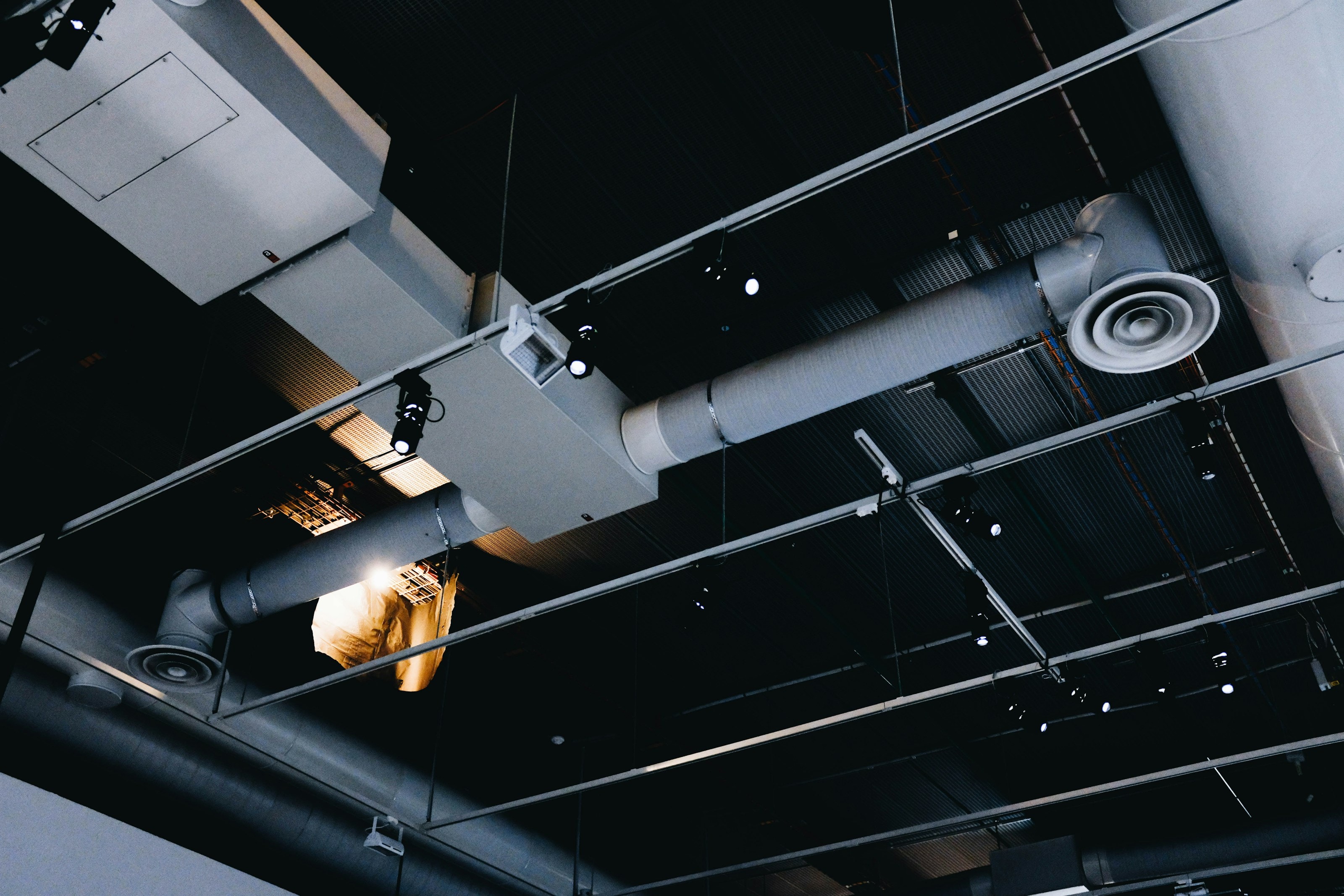 Supply ductwork and diffusers above a corridor ceiling